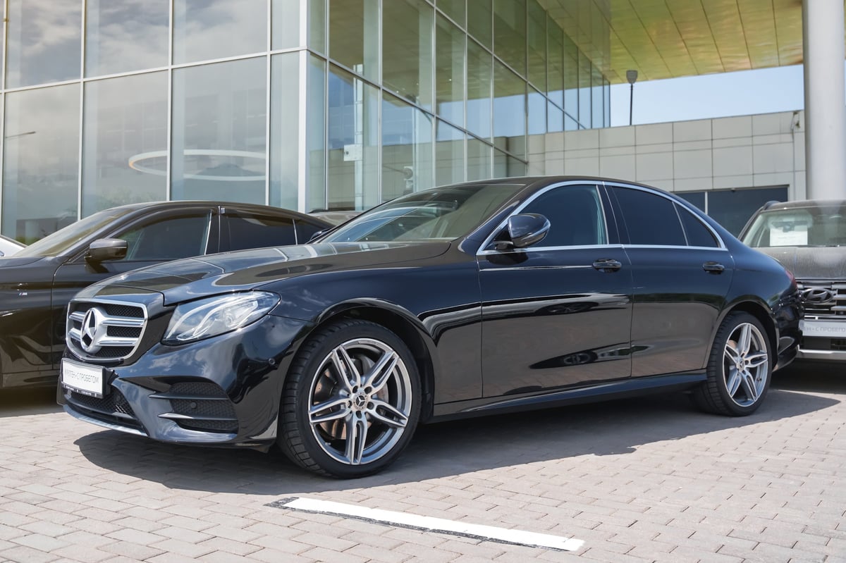 Black Mercedes-Benz E-Class parked in elegant setting representing luxury vehicle ownership